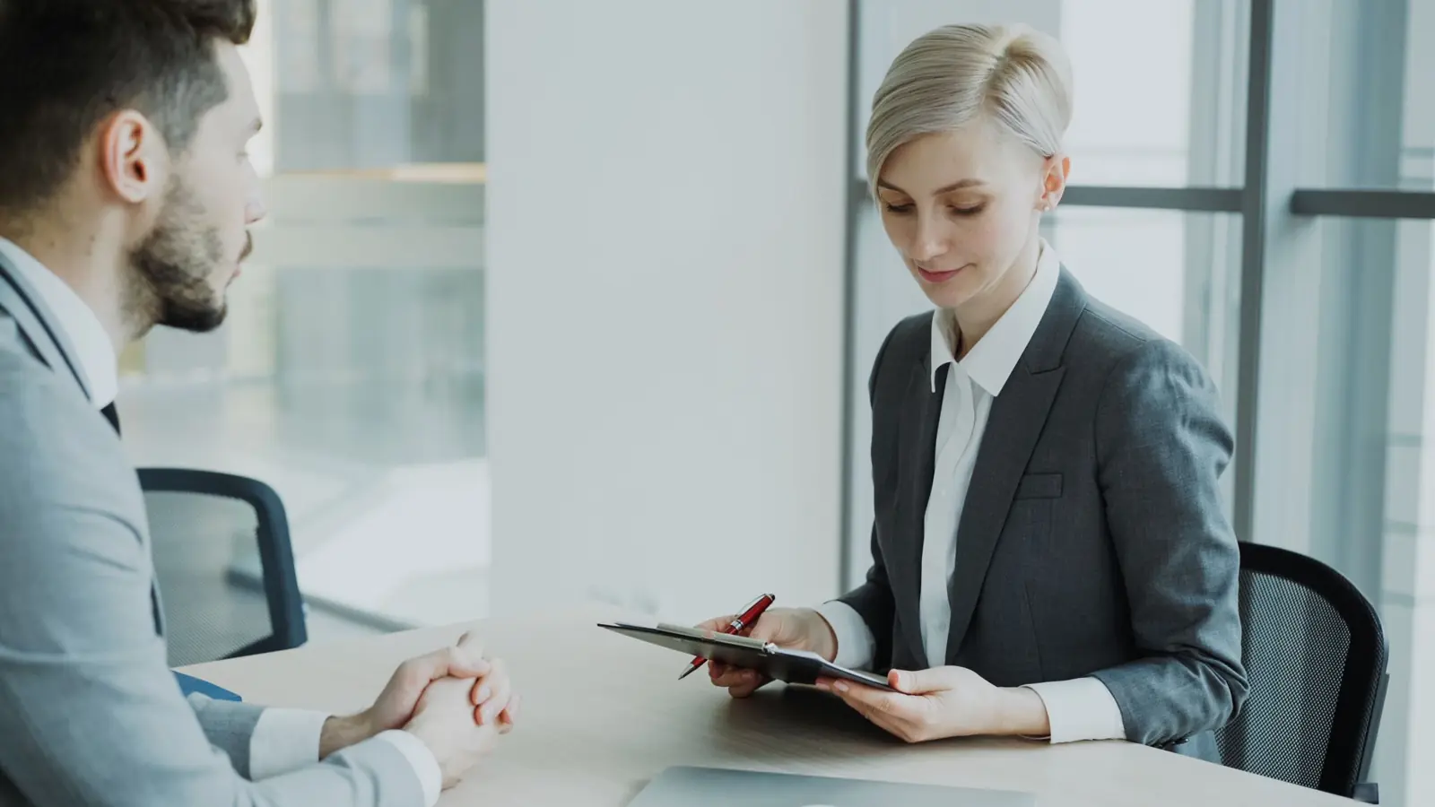 Two professionals in conversation in a bright office