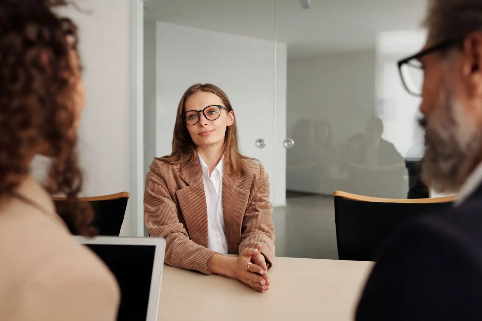 A candidate sitting confidently during a job interview in an office