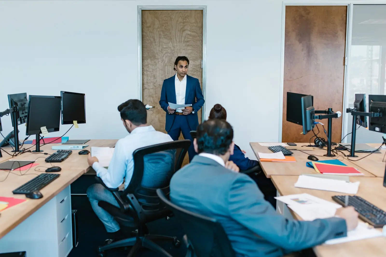A recruitment team in discussion in an open-plan office